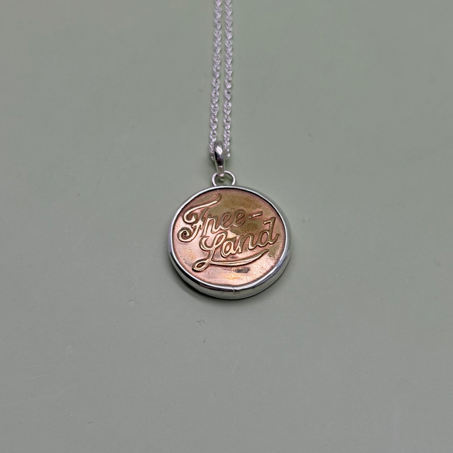 “Free Land” Script Union Button Necklace