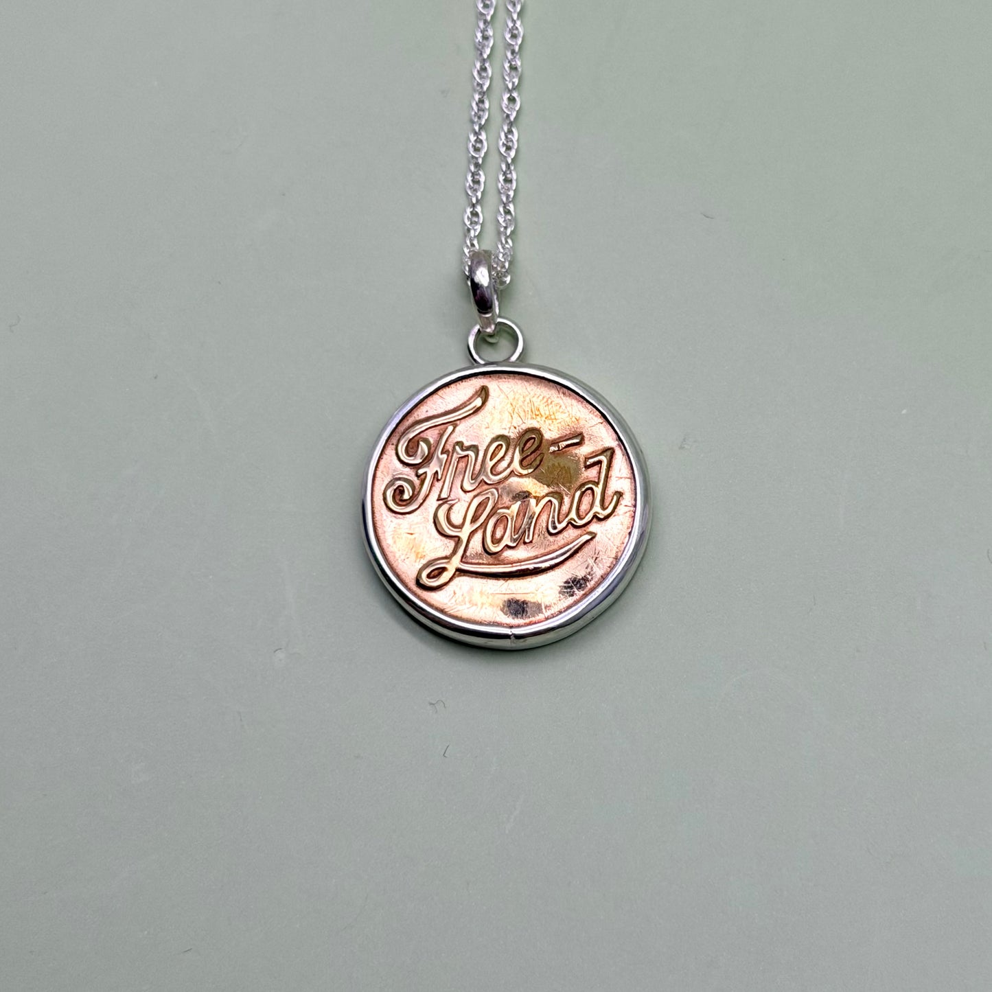 “Free Land” Script Union Button Necklace