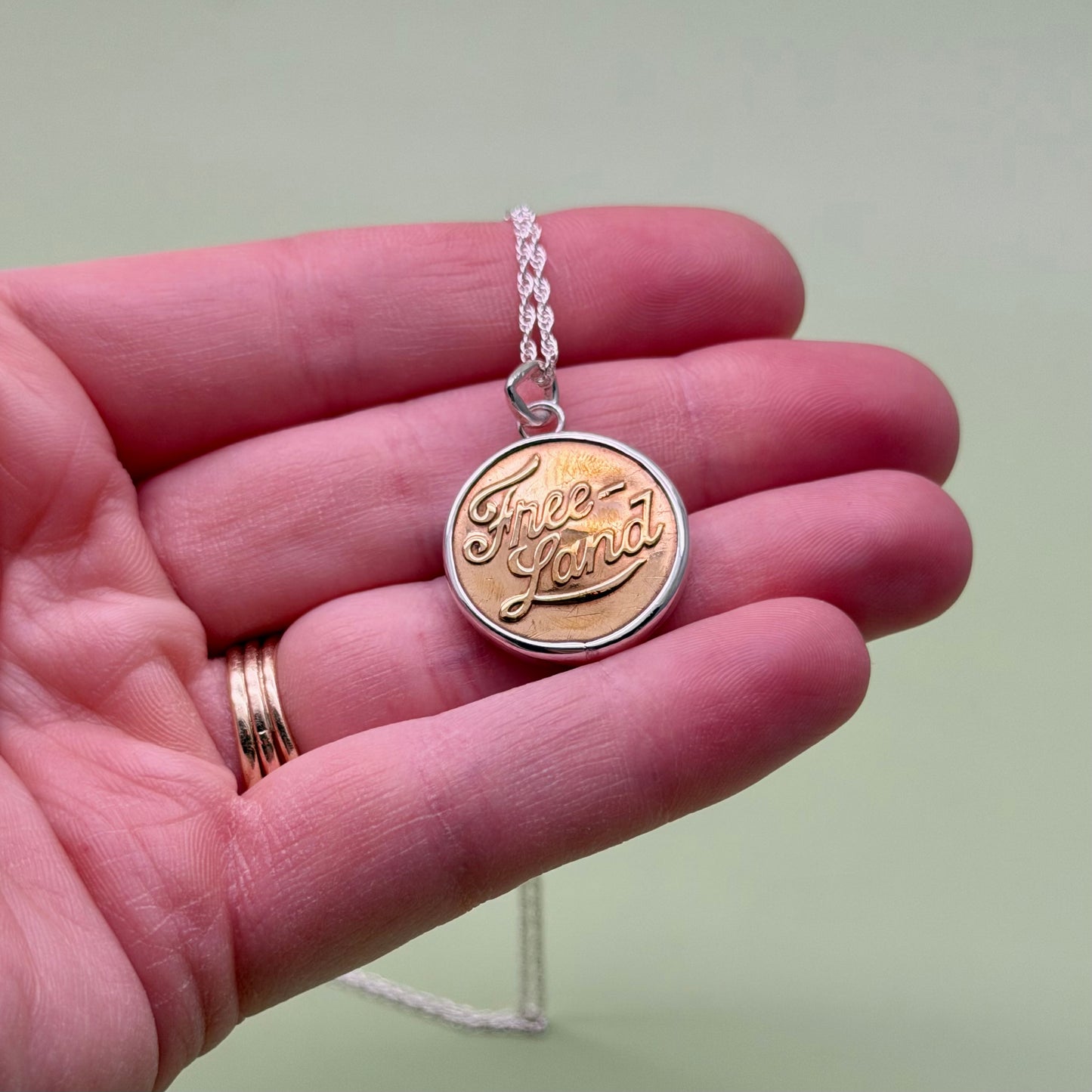 “Free Land” Script Union Button Necklace